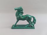 statue d'un cheval vert sur un socle vert, sur fond blanc