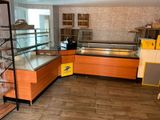a display case in the middle of a room with shelves
