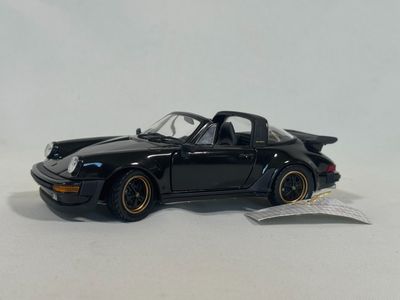 the toy car is black and has gold rims on it