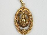 an image of a gold plated pendant with an image of a woman in a circle