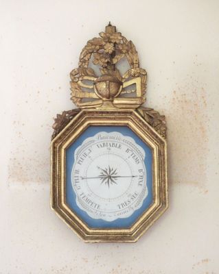 a clock hanging on the wall with a clock on it