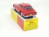 a red toy car sitting on top of a box
