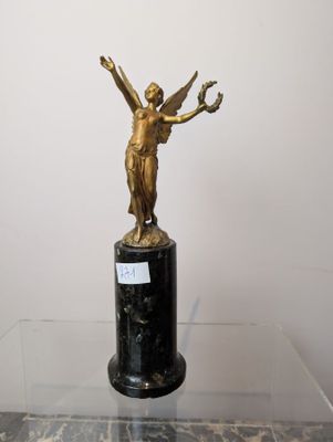 a statue of a woman on a pedestal on a table