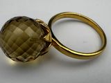 a close up of a ring with a large faceted smoky quartz stone