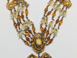 a close up of a necklace on a white surface