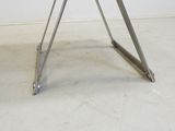 an image of a glass table with metal legs