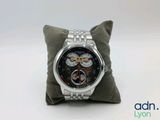 the watch is sitting on a pillow on a white surface