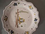 a plate with a bird on it on a table