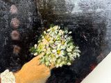 a painting of a hand holding a bunch of flowers
