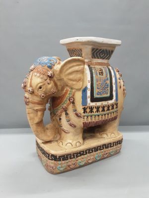 an elephant statue with a hat on it ' s head