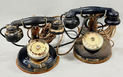 two old telephones that are sitting on a table