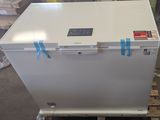 a white refrigerator sitting on a pallet in a warehouse