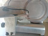 an image of a meat slicer sitting on a counter