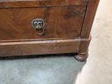 a small wooden chest with a lion head on it