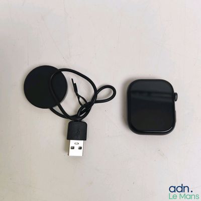 a black cell phone and a charger on a white table