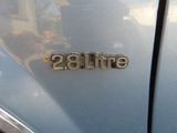 a close up of a car ' s emblem on the side of the car