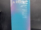 a book that is sitting on a table next to a remote