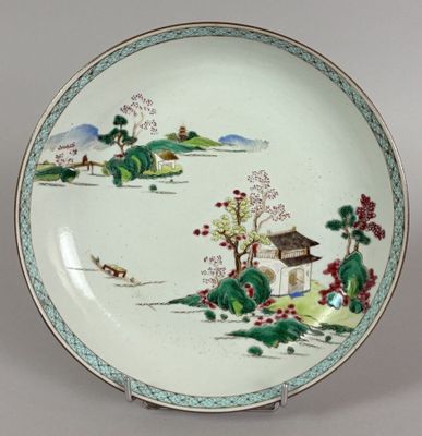 a plate with a painting on it on a table