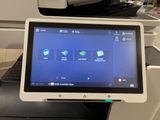 a tablet computer that is sitting on top of a printer