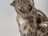 a figurine of a cat that is sitting on a table