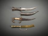 several different types of knives are displayed on a gray surface