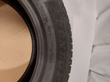 a close up of a tire on a white surface with a black rim