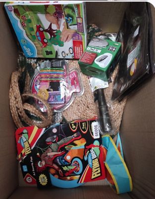 a cardboard box filled with toys and other items