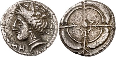 a silver coin with an image of a woman and a bird on it