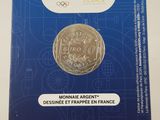 the back of a box with a coin in it on a white surface