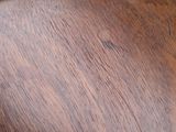 a close up view of a wooden table with a clock on it