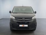 the front of a black van is parked in a room