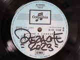 a black vinyl record with a blue label on it
