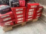 a pile of red boxes sitting on a pallet on the sidewalk