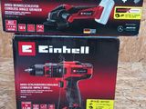 two boxes of electric tools sitting on top of a wooden surface