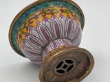 a vase with a flower on it sitting on a table