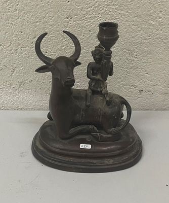 a statue of a man riding a bull with a child on it