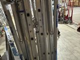a lot of metal bars stacked on top of each other in a warehouse