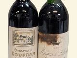 two bottles of wine sitting next to each other on a white surface