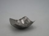 a silver bowl that is sitting on a table