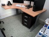a desk with two computer monitors and a printer on it