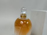 a bottle of perfume sitting on a table next to a box