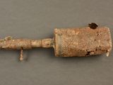 an old rusted pipe with a rusty handle on a gray surface