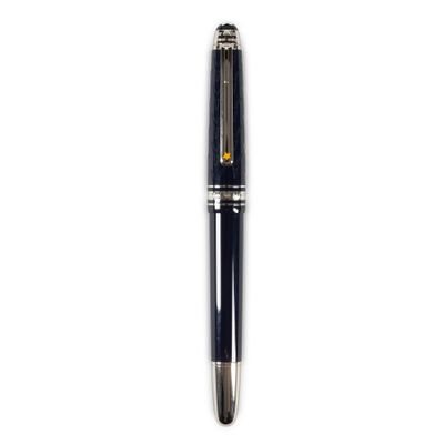 a close up of a pen on a white surface with a white background