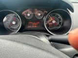 dashboard view of a car with a digital clock on the dashboard