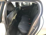 the back seat of a car with the door open and the passenger seat down
