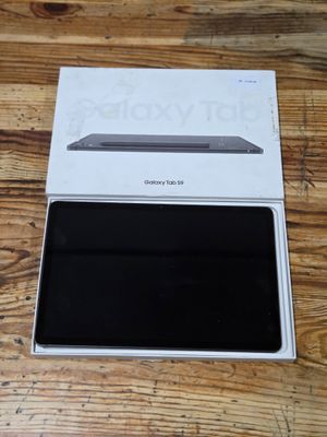 an open box on a wooden table with a laptop in it