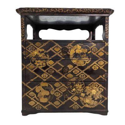 an image of a black and gold chest of drawers on a white background
