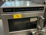 a microwave that is sitting on a counter in a kitchen