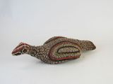 an image of a small bird made out of beads on a white surface