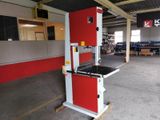 a red and white machine that is in a warehouse